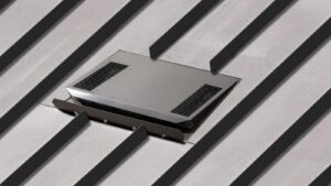 Low profile vent installed on a standing seam metal roof