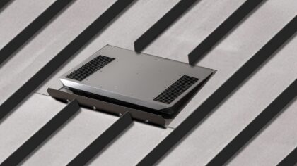 Low profile vent installed on a standing seam metal roof