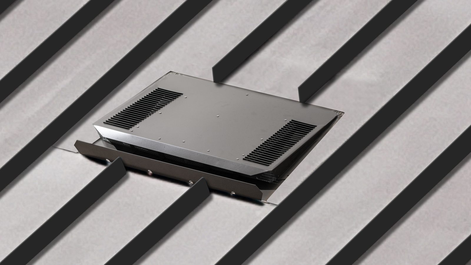 Low profile vent installed on a standing seam metal roof